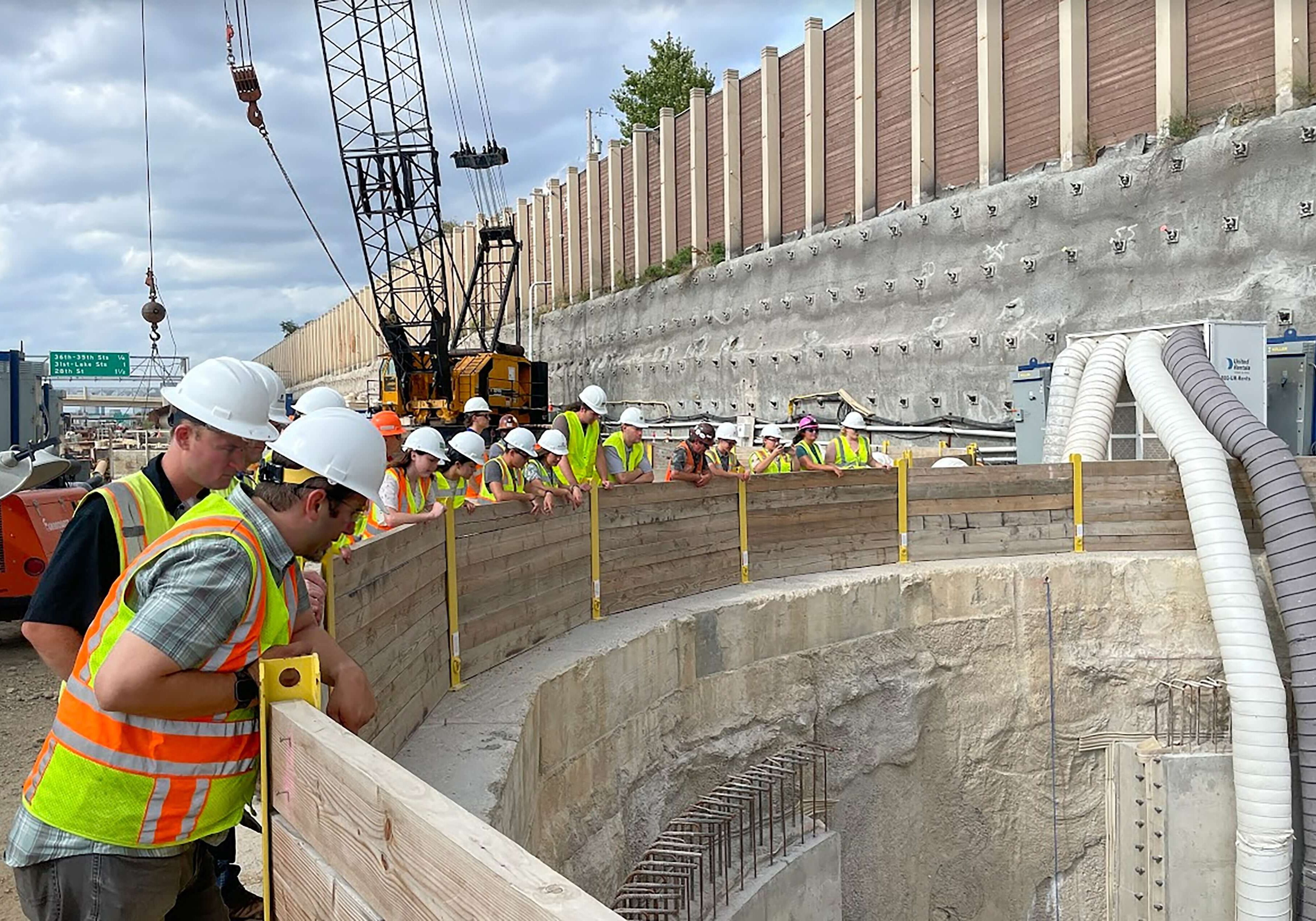 Engineers look down into stormwater basin